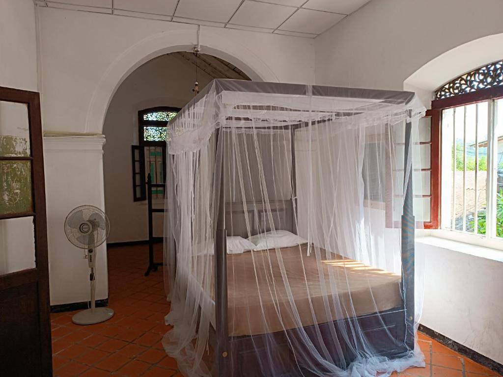 Bedroom with mosquito net and terracotta floor