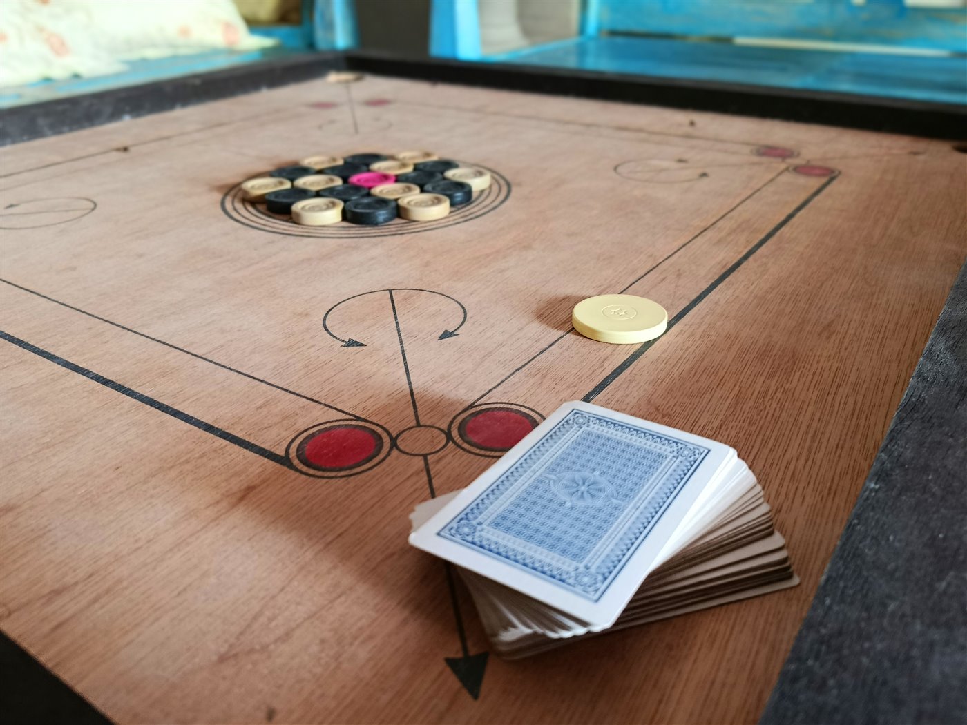 Carrom board and cards for indoor entertainment