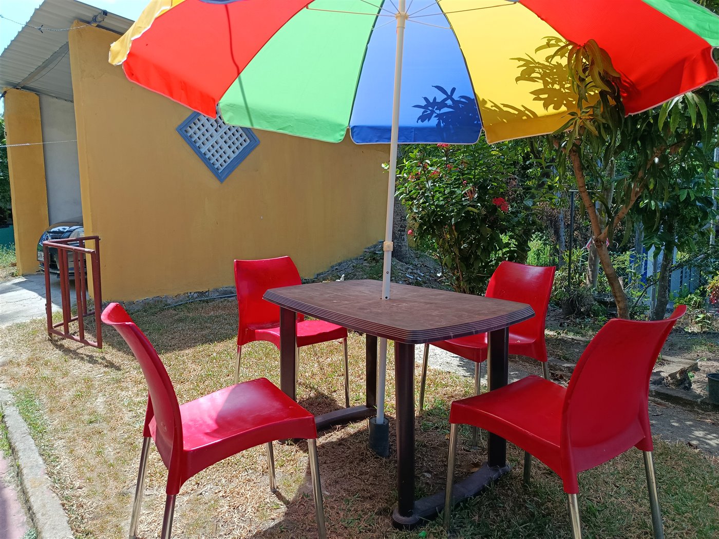 Garden terrace seating with colorful umbrella